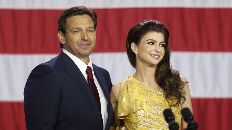 Ron DeSantis and wife Casey DeSantis in front of U.S. flag
