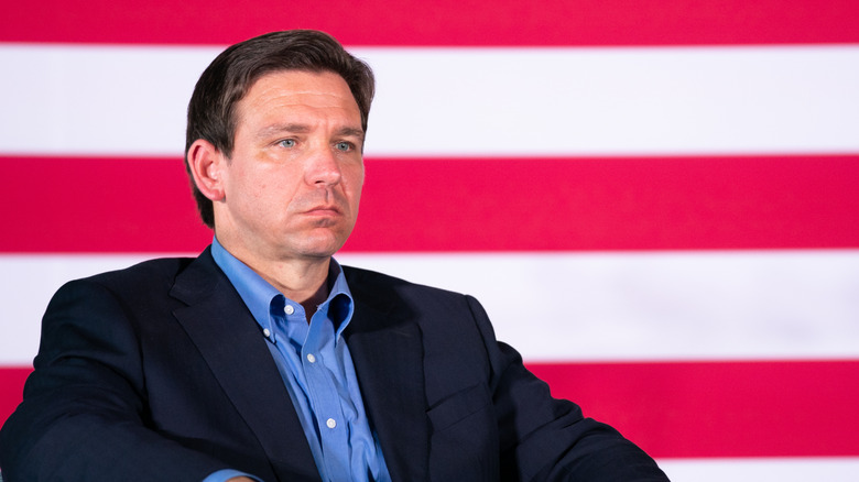 Ron DeSantis sitting in front of U.S. flag