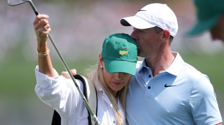Rory McIlroy kisses wife Erica Stoll during the Par Three Contest at Augusta National Golf Club in Georgia (2025)