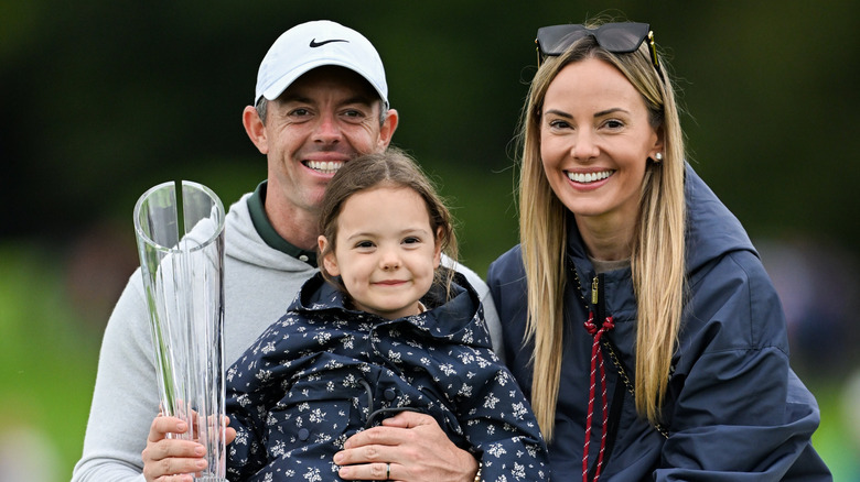 Rory McIlroy and Erica Stoll celebrate with their daughter