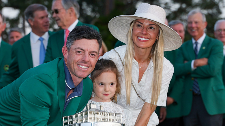 Rory McIlroy, Erica Stoll, and their daughter on the golf course