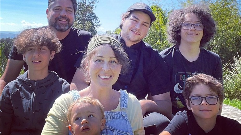 Jenny Pentland smiling with husband and five sons