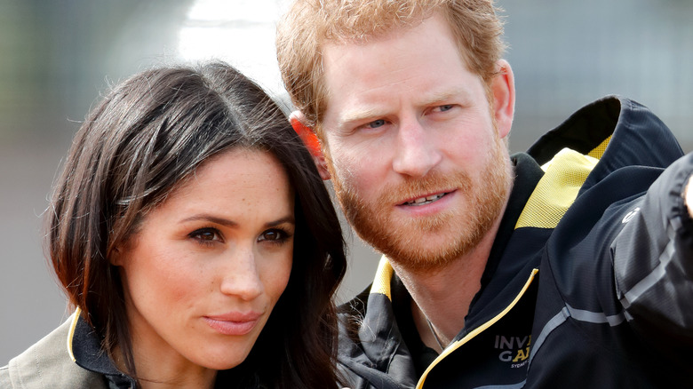 Prince Harry and Meghan Markle looking serious