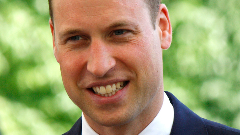 Prince William smiling and looking to side