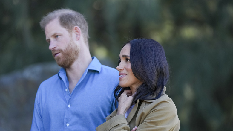 Prince Harry and Meghan Markle listening.