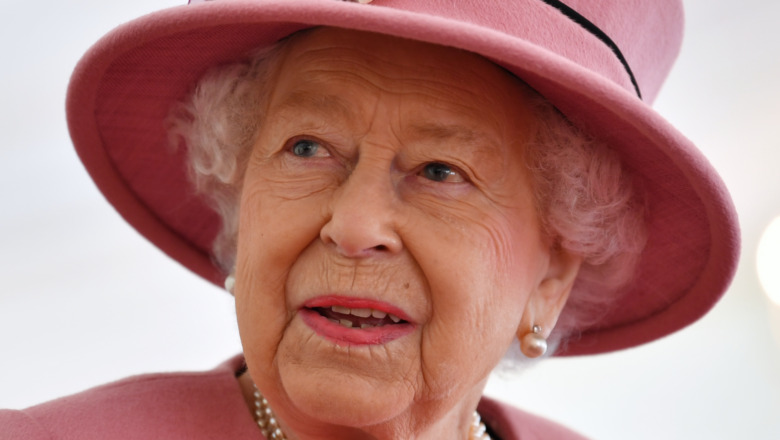 Queen Elizabeth II wears a pink hat