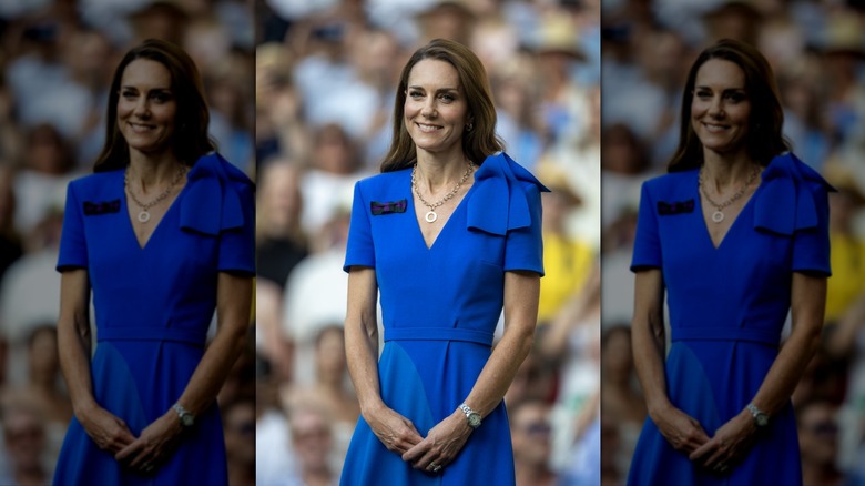 Kate Middleton smiling in front of Wimbledon crowd