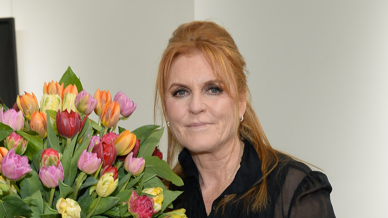 Sarah Ferguson posing next to flowers