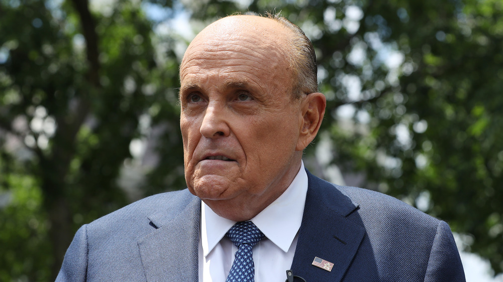 Rudy Giuliani with trees behind him