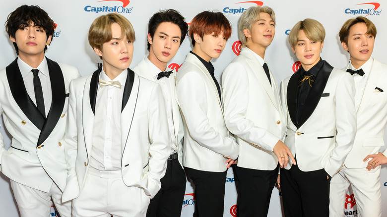 BTS posing in white tuxes