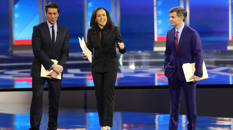 ABC network anchors and debate moderators David Muir, Linsey Davis and George Stephanopoulos speaking on stage prior to the Democratic presidential primary debate in the Sullivan Arena at St. Anselm College.