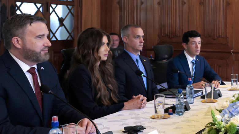Kristi Noem and Corey Lewandowski pictured side-by-side at a meeting in Guatemala.