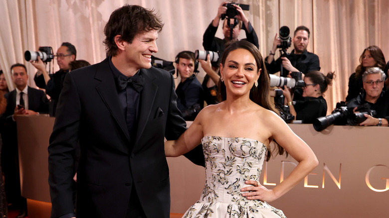 Ashton Kutcher and Mila Kunis laughing at 2026 Golden Globes