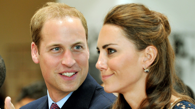 Prince William looks at Kate Middleton as she makes a funny face