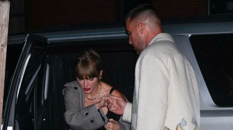 Travis Kelce helping Taylor Swift out of SUV