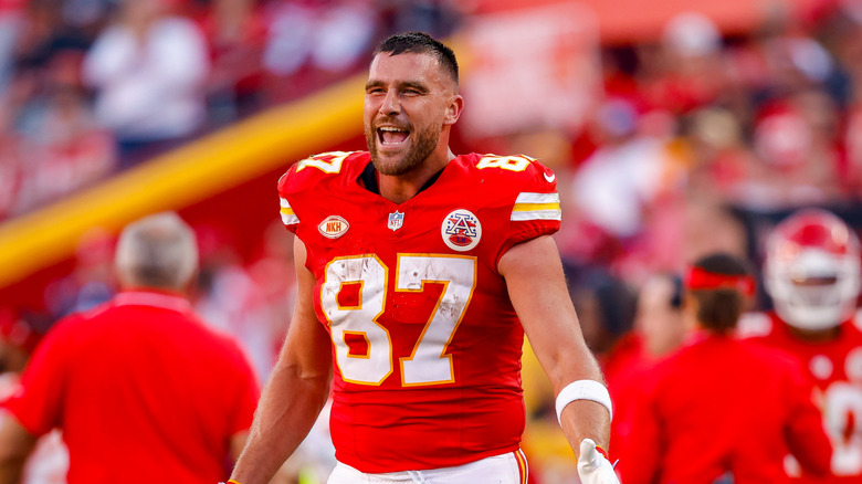 Travis Kelce smiling big on football field