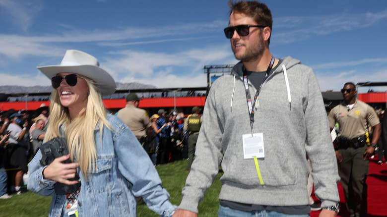 Kelly and Matthew Stafford holding hands