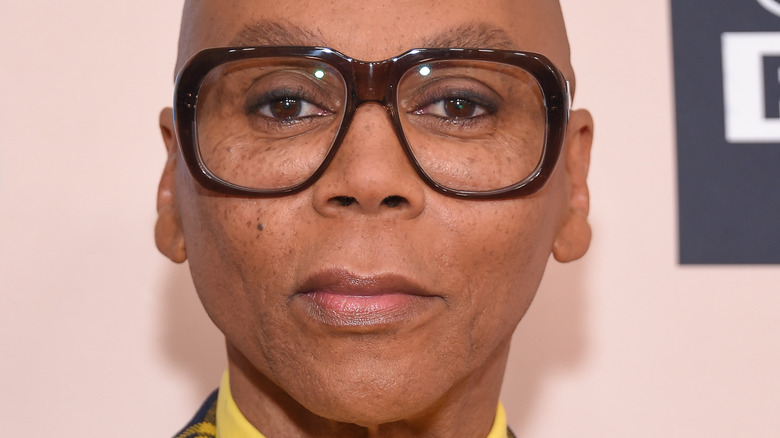 RuPaul in wide-rim brown glasses