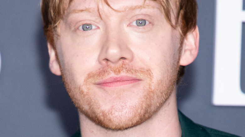 Rupert Grint grins on the red carpet