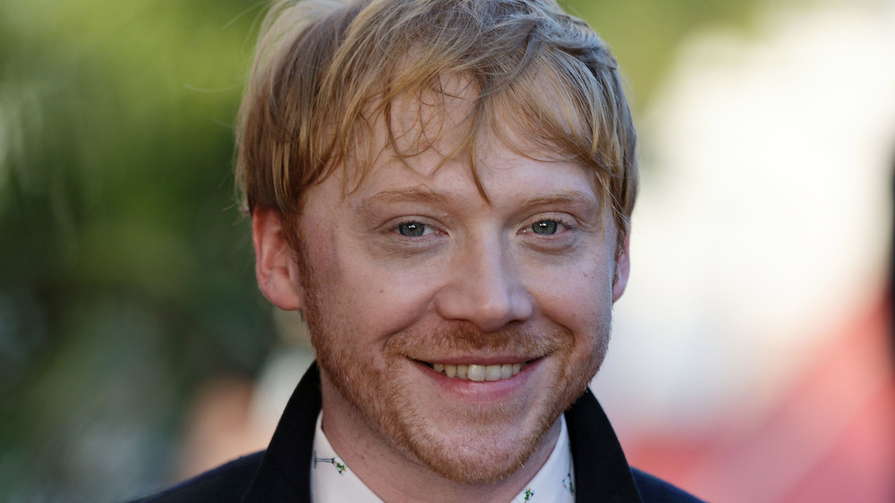 Rupert Grint poses at an event