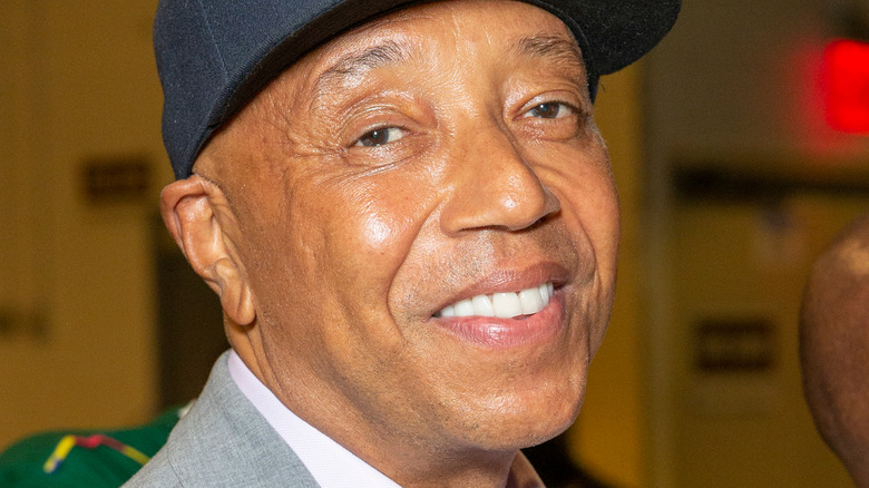 Russell Simmons smiles in a baseball cap