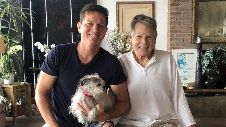 Patrick and Ryan O'Neal posing with dog