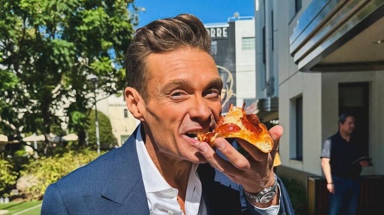 Ryan Seacrest eating pizza