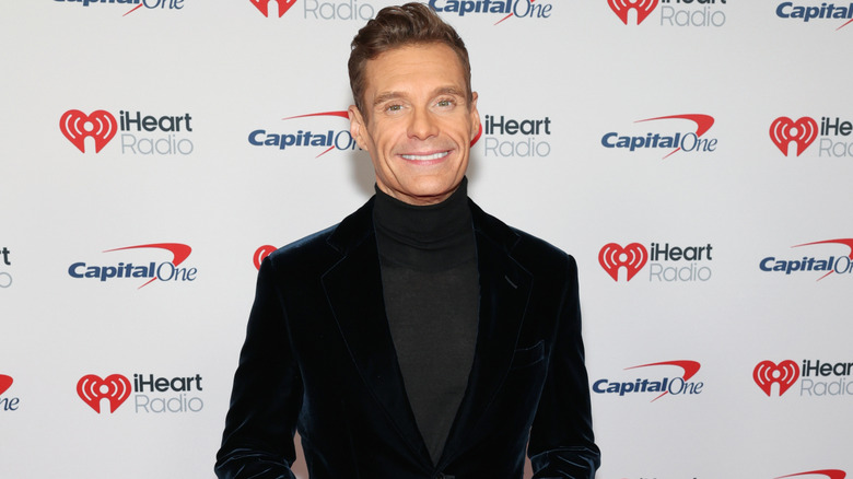 Ryan Seacrest posing in turtleneck