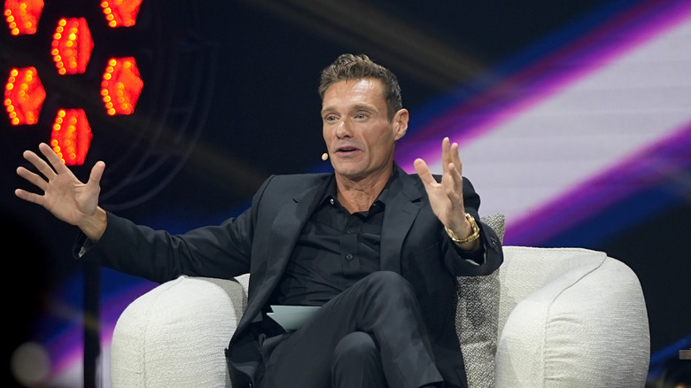 Ryan Seacrest speaks on stage in October 2025
