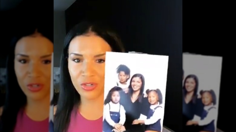 Page Turner holding a picture of herself and her daughters.