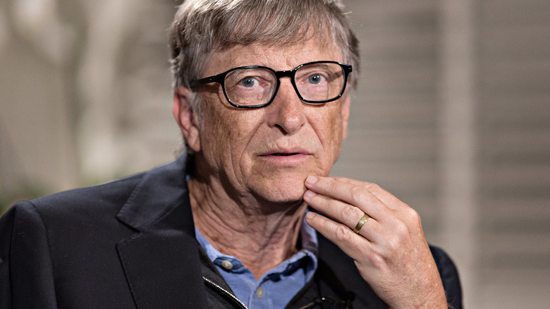 Bill Gates with his hand to his face
