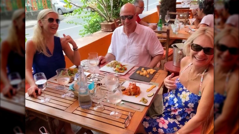 Chelsy Davy laughing with her parents.