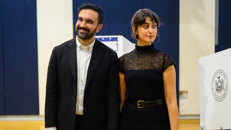 Zohran Mamdani and his wife, Rama Duwaji, holding hands