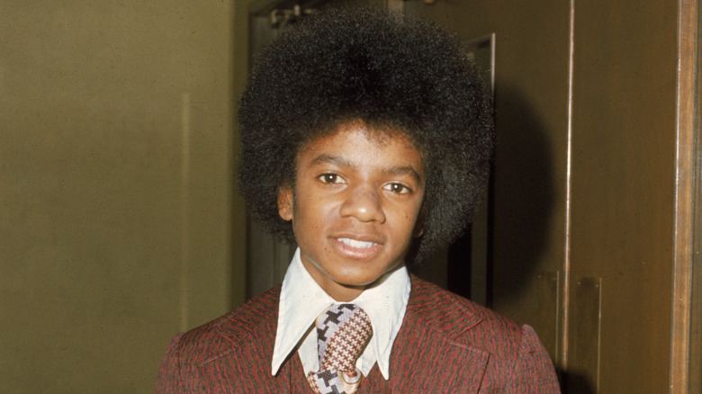 A young Michael Jackson posing at an event in the 70s.