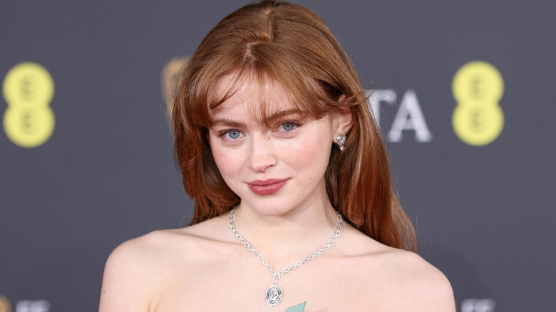 Sadie Sink wearing a green strapless gown at a red carpet event
