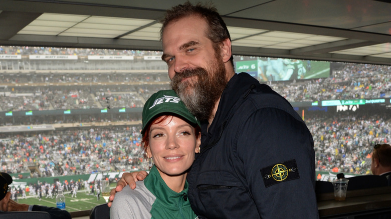 Lily Allen and David Harbour posing together at a football game.