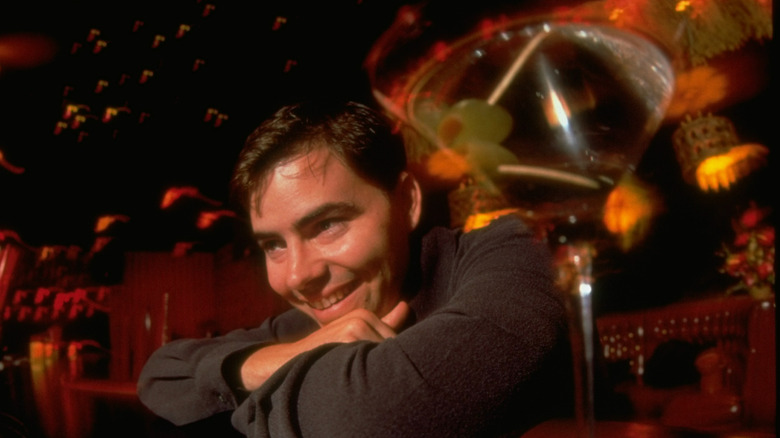 Peter Craig posing alongside martini in bar