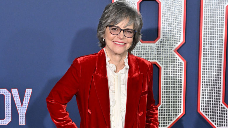 Sally Field smiling in a red blazer on the red carpet