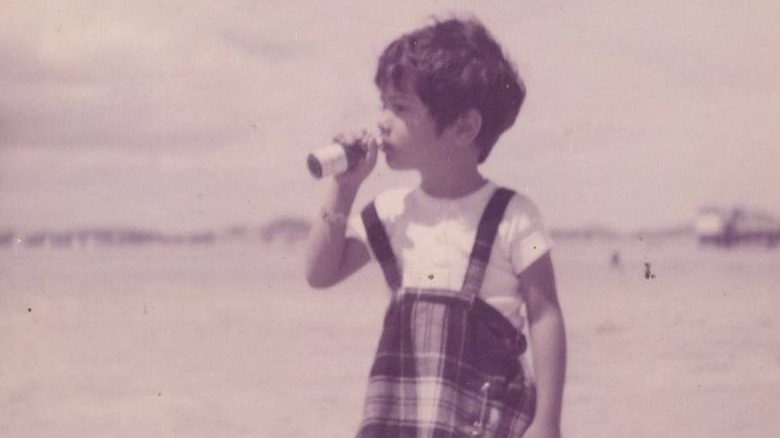 A young Salma Hayek posing on beach