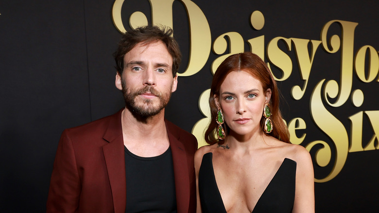Sam Claflin posing with Riley Keough