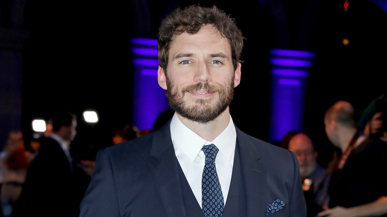Sam Claflin smiling at event