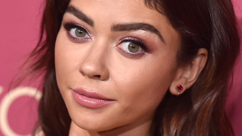 Sarah Hyland poses with pink stud earrings