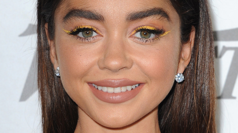 Sarah Hyland wearing yellow eyeliner and slightly smiling