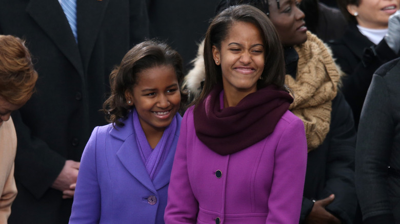 Sasha and Malia Obama wearing purple coats at the 2013 inauguration