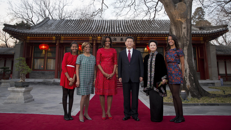 Michelle Obama, Malia Obama, Sasha Obama, and Marian Robinson posing outdoors with Chinese President Xi Jinping and his wife Peng Liyuan