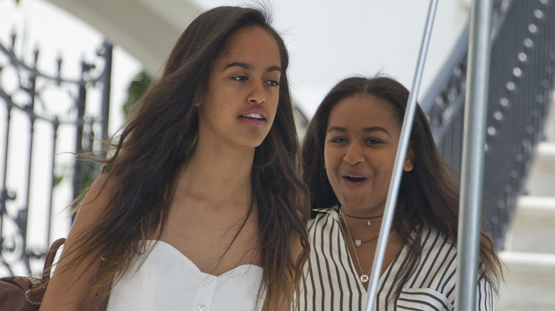 Malia and Sasha Obama walk together in 2016
