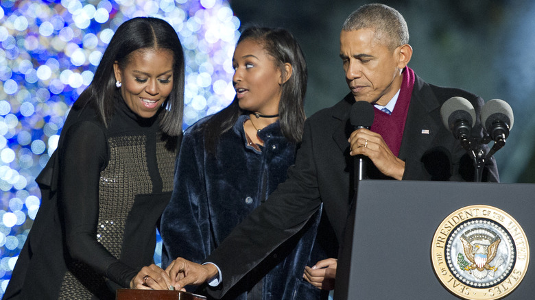 Teenage Sasha Obama on stage with her parents during her dad's presidency.
