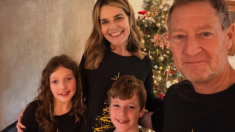 Savannah Guthrie and Michael Feldman with their kids in front of a Christmas tree