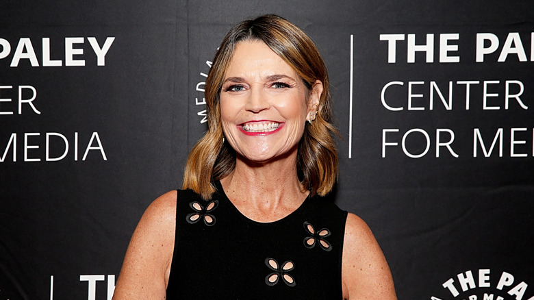 Savannah Guthrie wearing a black dress with floral eyelet cutouts at the Prime-Time Champions: An Evening with NBC Sunday Night Football at The Paley Center for Media.