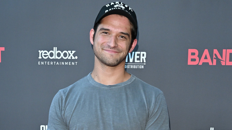 Tyler Posey wearing a baseball cap